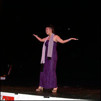 Student waving arms on stage