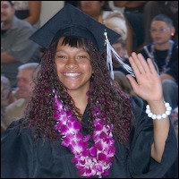 Graduate wearing cap and gown waves