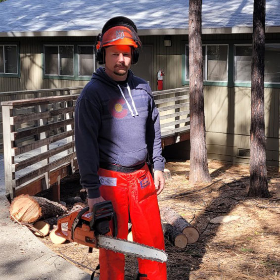 James Wagnon holding chainsaw