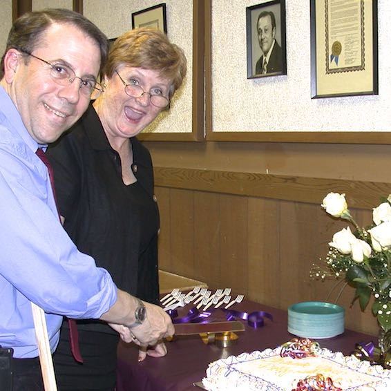 Rick Simpson and Patricia M. Thiel cutting a cake