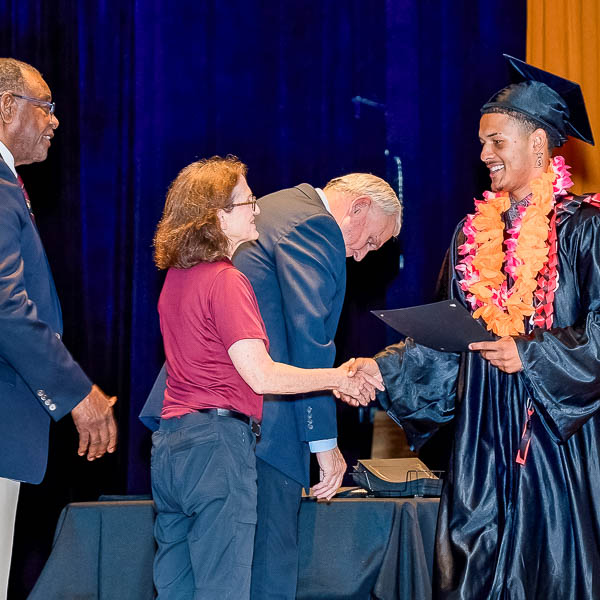Graduate shaking hands with trustees