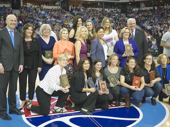 Teachers of the Year 2016 posing on the Kings court at Sleep Train Arena