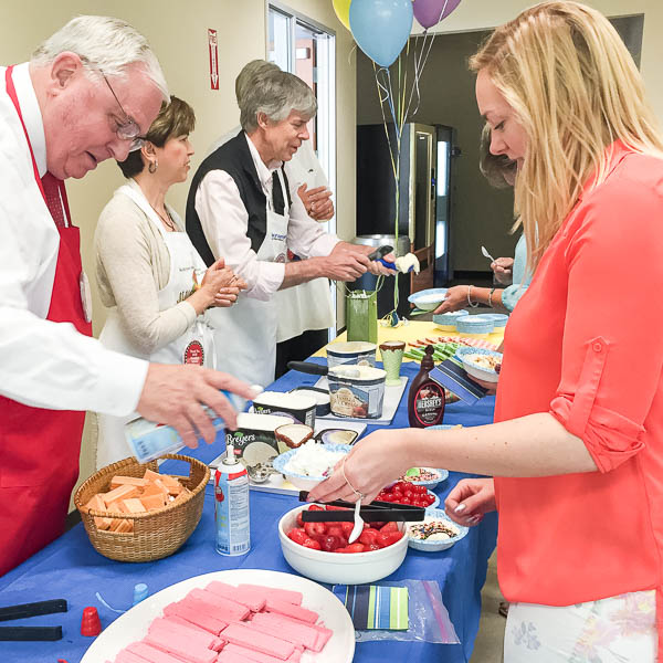 Superintendent and Cabinet members serving ice cream to staff