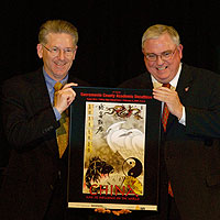 Henry Wirz and David W. Gordon holding poster