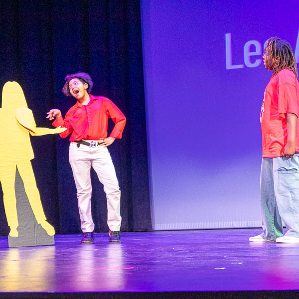 Students performing with cardboard cutout prop