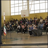 Audience seated in gym bleachers