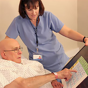 Nurse helping patient identify letters and numbers on paper