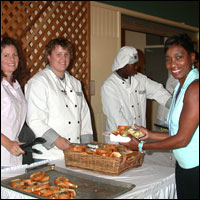 Students serving food to visitors