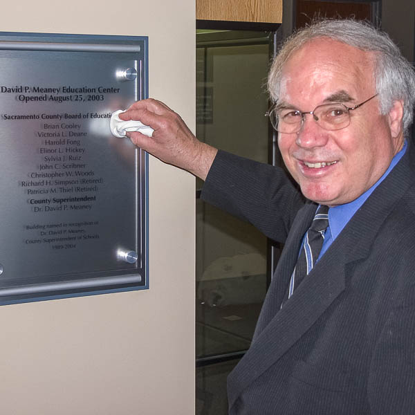 Dr. Meaney polishing the dedication plaque