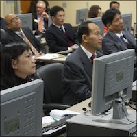 Chinese headmasters seated at computers