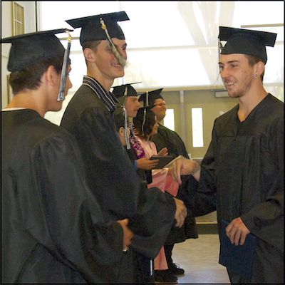 Graduates shaking hands