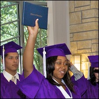 Graduate holding diploma in the air