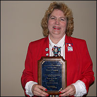 Mary Larson holding plaque