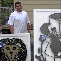 Student with framed metal lion and globe sculptures