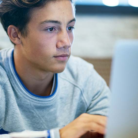 Student watching videos on laptop