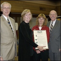David Schreuder, Linda Bidabe, Sharon Holstige, and Dr. Larry Reider holding certificate