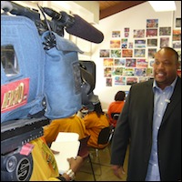 Daniel Watts standing in front of a video camera