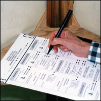 Close-up of hand marking a ballot sheet