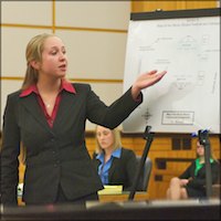 Mock Trial competitor pointing to a map