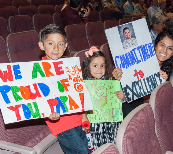 Small children holding congratulatory signs