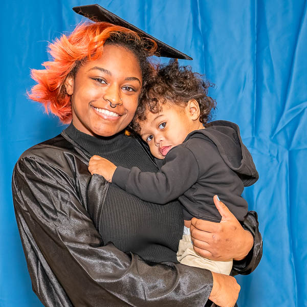 Graduate holding a child