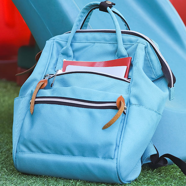 Backpack in front of a playground slide