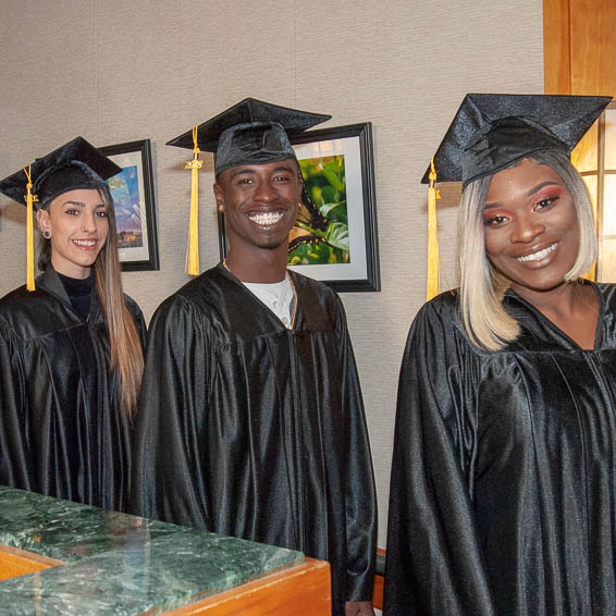 Graduates posing in caps and gowns