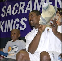 Ron Artest reading to students