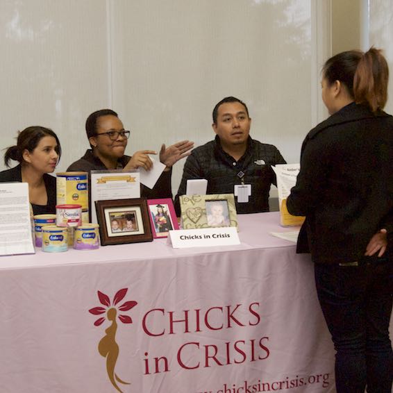 Student receiving information at Chicks in Crisis booth