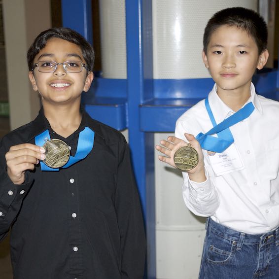 Students holding medals