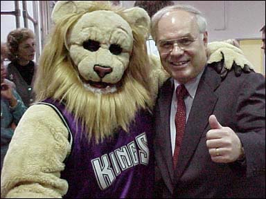 County Superintendent giving a thumbs-up while posing with Kings mascot