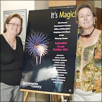 Employees with Art Show sign