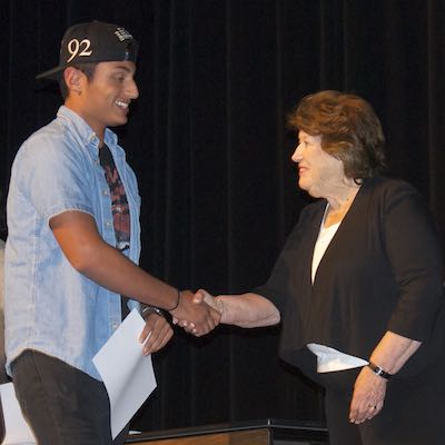 Student shaking hands with Board member