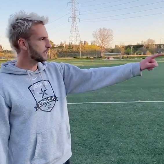 Player gesturing as he explains soccer concept
