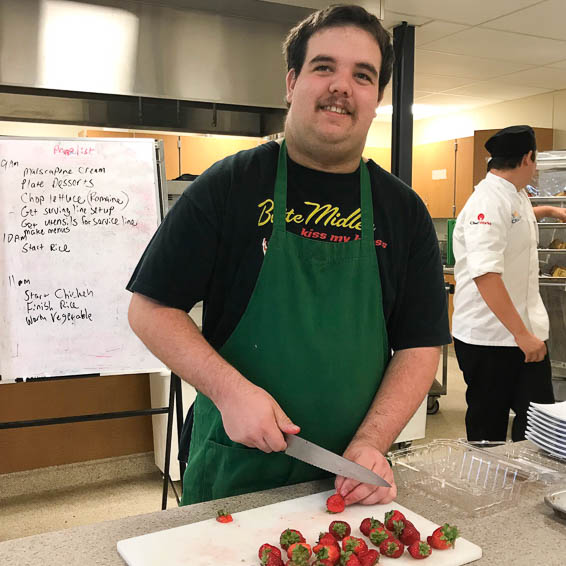 Student cutting strawberries
