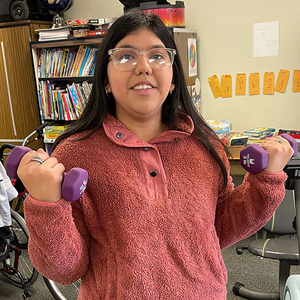 Student lifting dumbbells