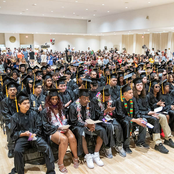 Rows of students wearing caps and gowns