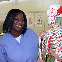 Student posing beside skeleton