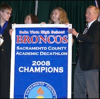Coaches receiving champions banner