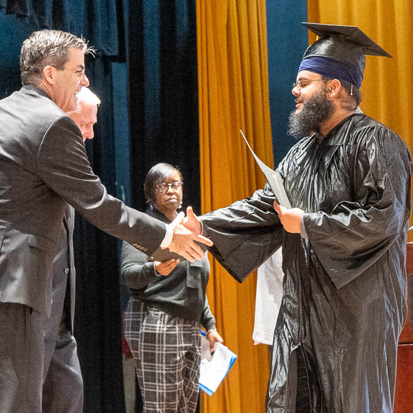 Graduate shaking hands with Paul Keefer