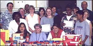 Group photo of students and staff with donations