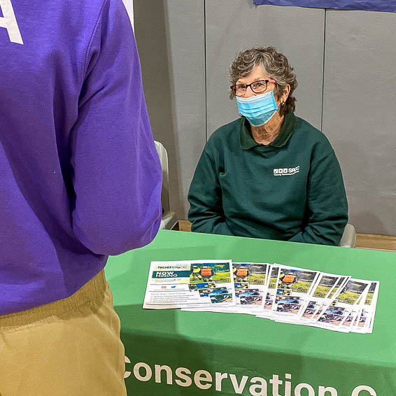 Student talking to Conservation Corps representative