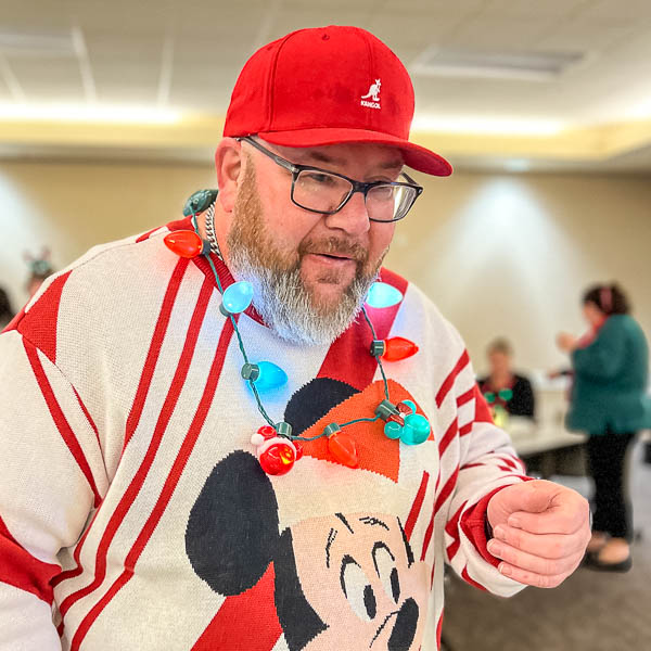 Staff member wearing battery powered holiday lights