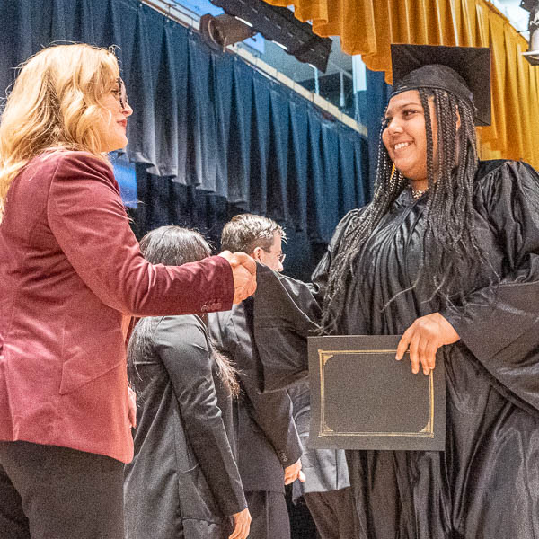 Graduate shaking hands with Jackie White
