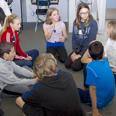 Group of students sitting in a circle talking