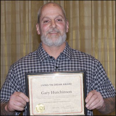 Award recipient holding certificate