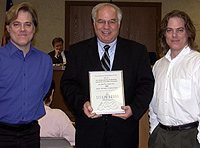 David Meaney presenting plaque to Mike Fox and Ray Fox