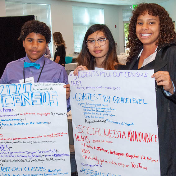Students holding handwritten action plans