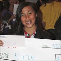 Winning student with check