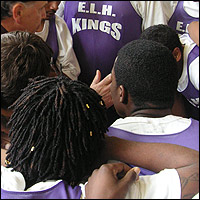 Players huddle around the coach